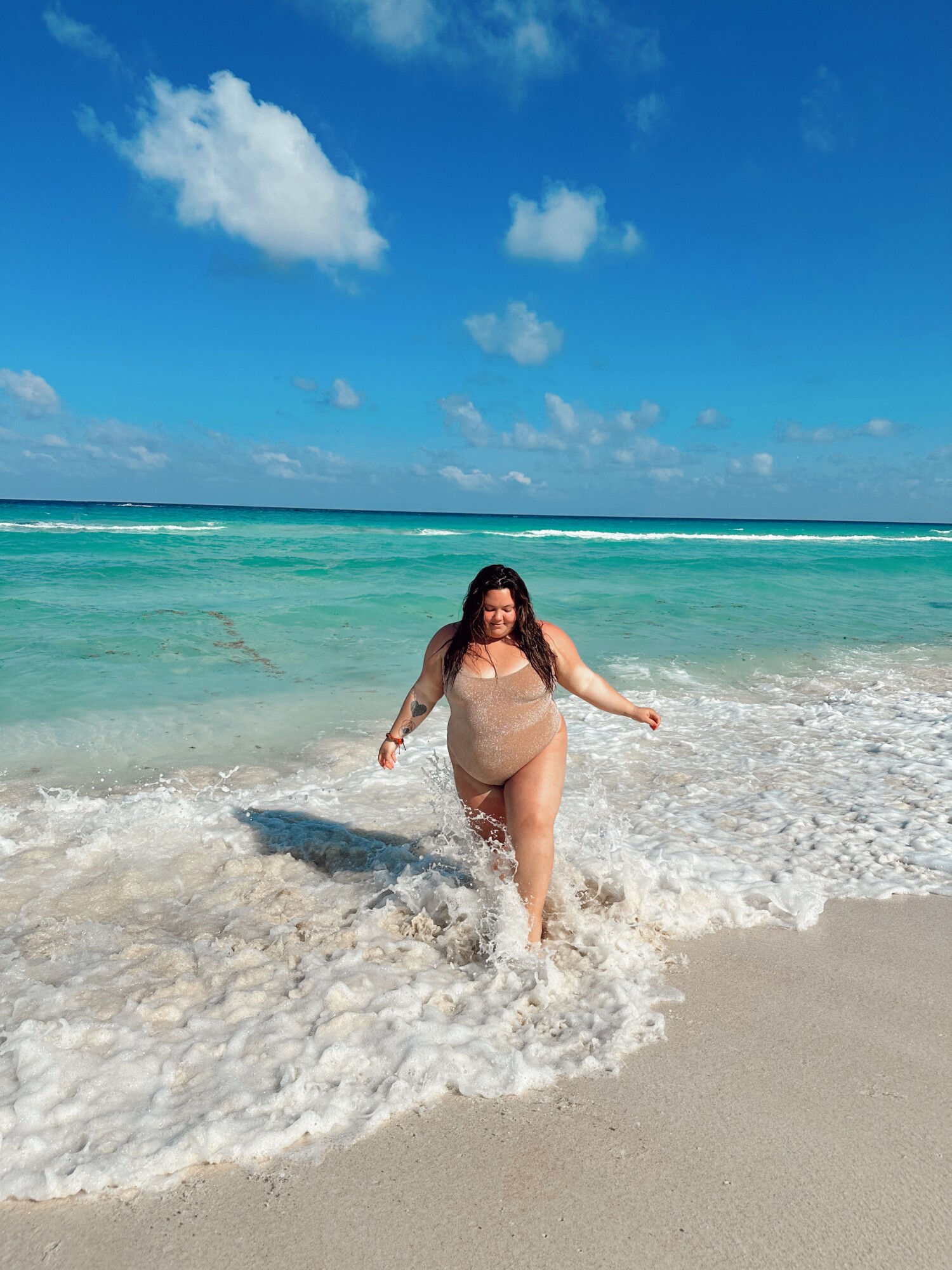 Where to buy plus size swimsuits from Natalie in the City who is wearing SKIMS one piece in Cancun