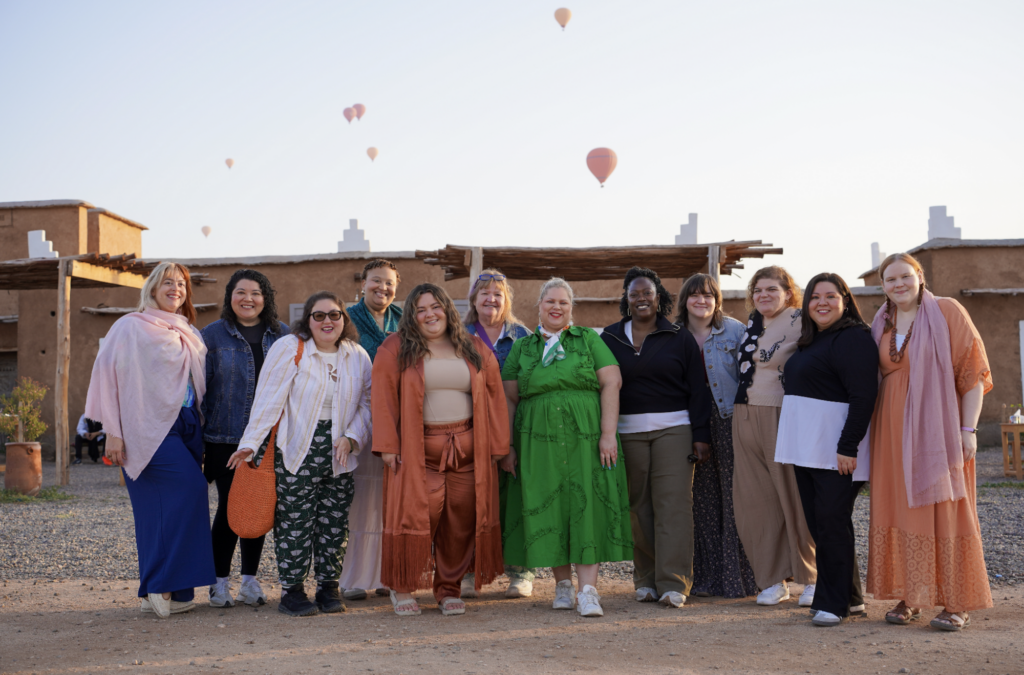 A group of women traveling in Marrakech, Morocco with hot air balloons in the back